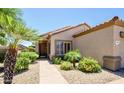 Inviting single-story home featuring desert landscaping, a tiled roof, and a welcoming front entrance at 19607 N Flint Way, Surprise, AZ 85374