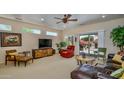 Cozy living room featuring a ceiling fan, slider to backyard, and comfortable seating area at 19607 N Flint Way, Surprise, AZ 85374