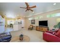 Bright living room featuring recessed lighting, an entertainment center, and a peek into the dining area at 19607 N Flint Way, Surprise, AZ 85374