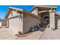 Charming single-story home with a well-maintained two-car garage, walkway, and desert landscaping at 19930 N 98Th Ave, Peoria, AZ 85382