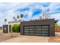 Charming single-story home featuring unique architectural details and desert landscaping, a modern garage door and drought tolerant plantings at 2033 E Janice Way, Phoenix, AZ 85022