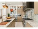 Gourmet kitchen featuring marble countertops and backsplash, stainless steel appliances, and custom cabinetry at 21240 N 74Th Pl, Scottsdale, AZ 85255