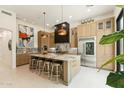 Modern, eat-in kitchen with stainless steel appliances, marble countertops, and light wood cabinetry at 21240 N 74Th Pl, Scottsdale, AZ 85255