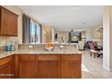 Open kitchen overlooking living area, featuring granite countertops and a breakfast bar seating area at 2150 W Alameda Rd # 1313, Phoenix, AZ 85085