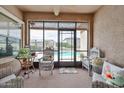 Cozy screened-in patio offering comfortable seating and tranquil views of the backyard pool area at 21968 W Hadley St, Buckeye, AZ 85326