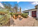 Inviting brick courtyard with an umbrella and a pair of wooden Adirondack chairs, perfect for relaxation at 2801 N 10Th St, Phoenix, AZ 85006