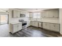 Modern kitchen boasts stainless steel appliances, granite countertops, and a stylish backsplash at 3017 N 46Th Dr, Phoenix, AZ 85031