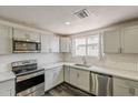 Modern kitchen boasts stainless steel appliances, granite countertops, and a stylish backsplash at 3017 N 46Th Dr, Phoenix, AZ 85031