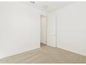 Bright bedroom featuring neutral carpet, white walls, and a closet at 37114 W La Paz St, Maricopa, AZ 85138