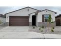 Charming single-story home featuring a well-manicured yard and a two-car garage with neutral color palette at 37154 W Prado St, Maricopa, AZ 85138