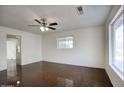 Bright and airy living room with large windows and a modern ceiling fan at 3841 N 21St Ave, Phoenix, AZ 85015