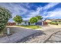 Charming single-story home featuring manicured landscaping, solar panels, and a spacious driveway at 4162 W Sierra St, Phoenix, AZ 85029