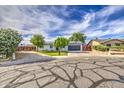 Charming single-story home featuring manicured landscaping, solar panels, and a spacious driveway at 4162 W Sierra St, Phoenix, AZ 85029