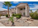 Beautiful two-story home features a well-maintained yard, desert landscaping, and cozy porch seating at 43228 W Knauss Dr, Maricopa, AZ 85138