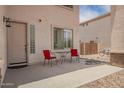 Inviting front patio features outdoor seating, perfect for enjoying warm weather and neighborhood views at 43228 W Knauss Dr, Maricopa, AZ 85138