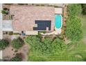 Aerial view of home with solar panels, tile roof, pool, and lush backyard at 5029 S Carlyle Dr, Gilbert, AZ 85298