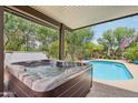 Outdoor hot tub adjacent to a sparkling pool offers a backyard oasis at 5029 S Carlyle Dr, Gilbert, AZ 85298