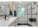 Modern bathroom with marble tiling, glass shower, and dark fixtures for a sleek design at 508 W San Angelo St, Gilbert, AZ 85233