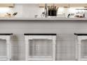 Kitchen island with white wooden stools and white countertop, offering a clean and stylish look at 508 W San Angelo St, Gilbert, AZ 85233