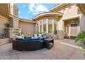 Cozy outdoor living space with a stone fireplace, comfortable seating, and serene ambiance in private courtyard at 5291 S Bradshaw Pl, Chandler, AZ 85249