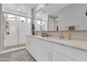 Bright bathroom features double sinks, white cabinets and a glass enclosed shower at 717 N Abalone Ct, Gilbert, AZ 85233