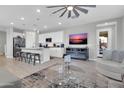 Bright living room with an open floor plan, modern furnishings, and a ceiling fan above at 717 N Abalone Ct, Gilbert, AZ 85233