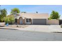 Single-story home featuring a neutral exterior, desert landscaping, and a two-car garage at 7337 E Ivyglen St, Mesa, AZ 85207