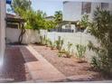 Private backyard patio with red brick pathway and gravel bed at 8653 S 51St St # 2, Phoenix, AZ 85044