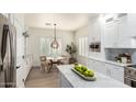 Eat-in kitchen with white cabinets, marble countertops, stainless steel appliances, and window shutters at 896 E Indian Wells Pl, Chandler, AZ 85249