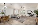 Bright and airy living room featuring modern decor, light-colored wood floors and plantation shutters at 896 E Indian Wells Pl, Chandler, AZ 85249