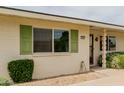 This house's exterior boasts green shutters, desert landscaping, and a welcoming facade at 9265 N 111Th Ave, Sun City, AZ 85351