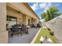 Spacious covered patio with dining area, lounge seating and artificial turf at 948 E Savannah Dr, Chandler, AZ 85225
