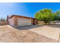 Charming single-story brick home with a two-car garage, long driveway, and low-maintenance landscaping at 10032 N 50Th Dr, Glendale, AZ 85302