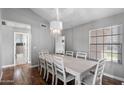 Dining room featuring wood floors, a chandelier, and white dining set at 11131 E Becker Ln, Scottsdale, AZ 85259