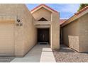 Close up of front entrance featuring desert landscaping and pathway leading to wood double doors at 11131 E Becker Ln, Scottsdale, AZ 85259