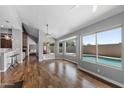 Open living room with hardwood floors, fireplace, and view of the pool and backyard at 11131 E Becker Ln, Scottsdale, AZ 85259