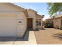 Inviting single-story home featuring a two-car garage and neutral-colored exterior at 11921 W Flores Dr, El Mirage, AZ 85335
