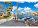 Waterfront backyard oasis complete with a boat dock, paddleboards, built-in fireplace, and lush landscaping at 1241 W Lobster Trap Dr, Gilbert, AZ 85233