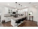 Modern kitchen featuring white cabinets, a marble island, and stainless steel appliances at 1250 N Abbey Ln # 206, Chandler, AZ 85226