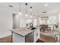 Bright, modern kitchen featuring an island with bar seating, white cabinets, and open layout at 1250 N Abbey Ln # 206, Chandler, AZ 85226