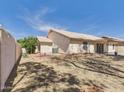 Large backyard space with gravel landscaping, block fence, and covered patio at 13431 N 30Th St, Phoenix, AZ 85032