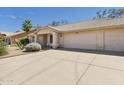Wide driveway leads to a two-car garage of this charming, single-story home with desert landscaping at 13431 N 30Th St, Phoenix, AZ 85032