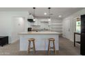 Bright kitchen featuring modern white cabinets, a peninsula, and stainless steel appliances at 1408 E Orange St, Tempe, AZ 85281