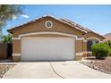 Charming single-story home featuring a two-car garage and desert landscaping under a clear blue sky at 15805 W Morning Glory St, Goodyear, AZ 85338