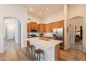 Bright, open kitchen with a large island, stainless steel appliances, and wooden cabinetry at 1635 E Harrison St, Chandler, AZ 85225