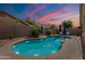 Backyard pool area features a sparkling pool, palm trees, patio seating, and privacy wall at 1635 E Harrison St, Chandler, AZ 85225