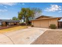 Suburban single-story home with a two-car garage, mature trees and easy to maintain desert landscaping at 1874 E Huntington Dr, Tempe, AZ 85282