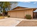 A close up of a two car garage on a one story home with mature landscaping at 1874 E Huntington Dr, Tempe, AZ 85282