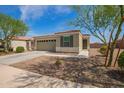 Charming single-story home with a two-car garage and neutral stucco exterior, complemented by desert landscaping at 19951 W Wilson St, Buckeye, AZ 85326