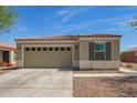 Charming single-story home with a two-car garage and neutral stucco exterior, complemented by desert landscaping at 19951 W Wilson St, Buckeye, AZ 85326